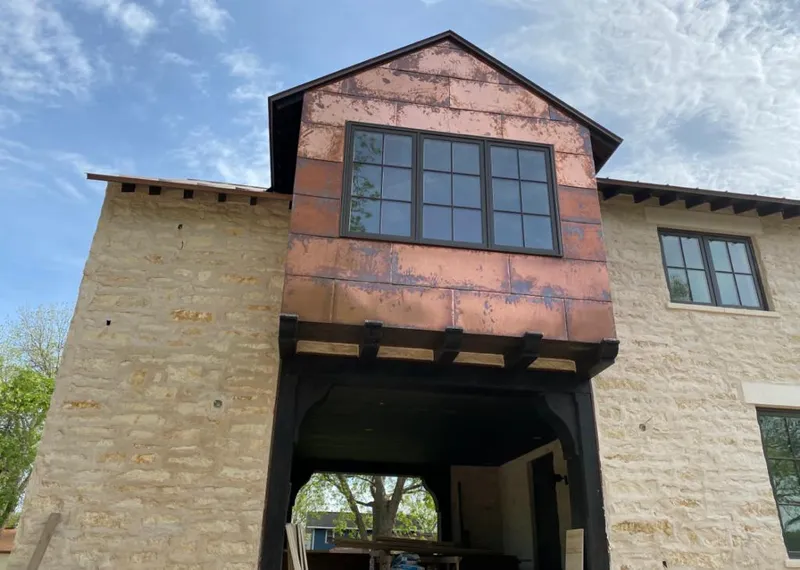 Copper metal panel facade on a stone building for Roof Repair in Sun Lakes